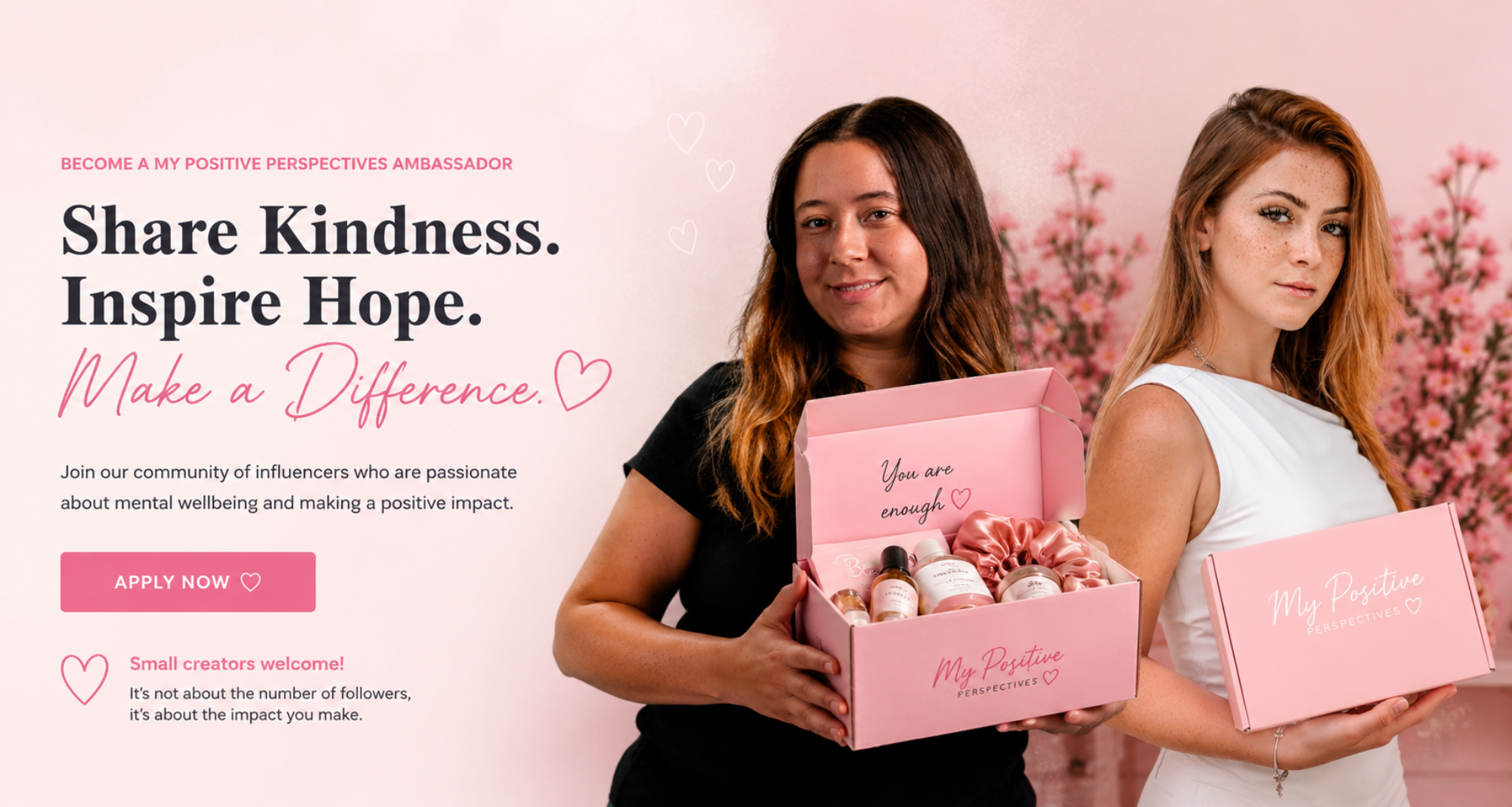 Two women standing side by side holding pink 'My Positive Perspectives' gift boxes in a pink studio setting with floral background and promotional text on the left.